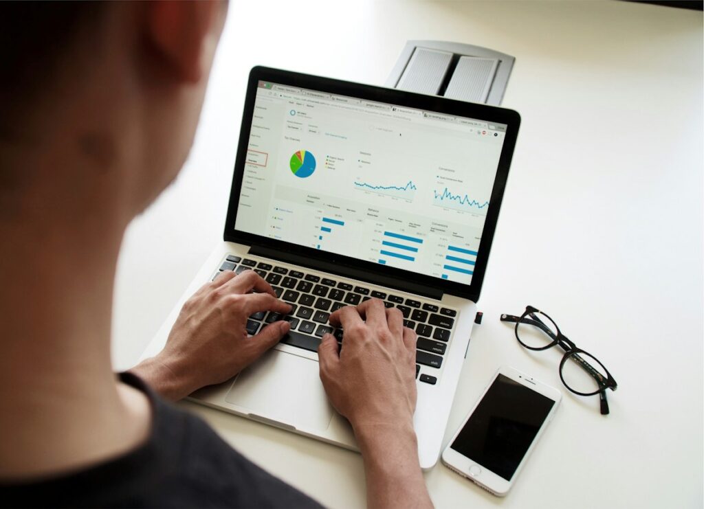 Aspiring data scientist analysing charts on a laptop while following a data science roadmap