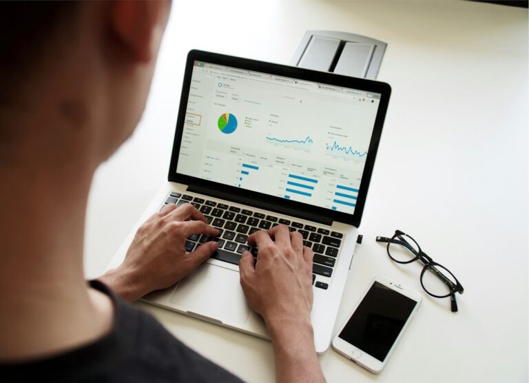 Aspiring data scientist analysing charts on a laptop while following a data science roadmap