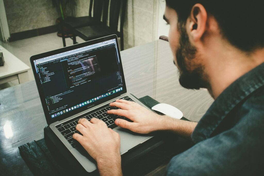 Data science learner coding on a laptop while preparing a job-ready portfolio